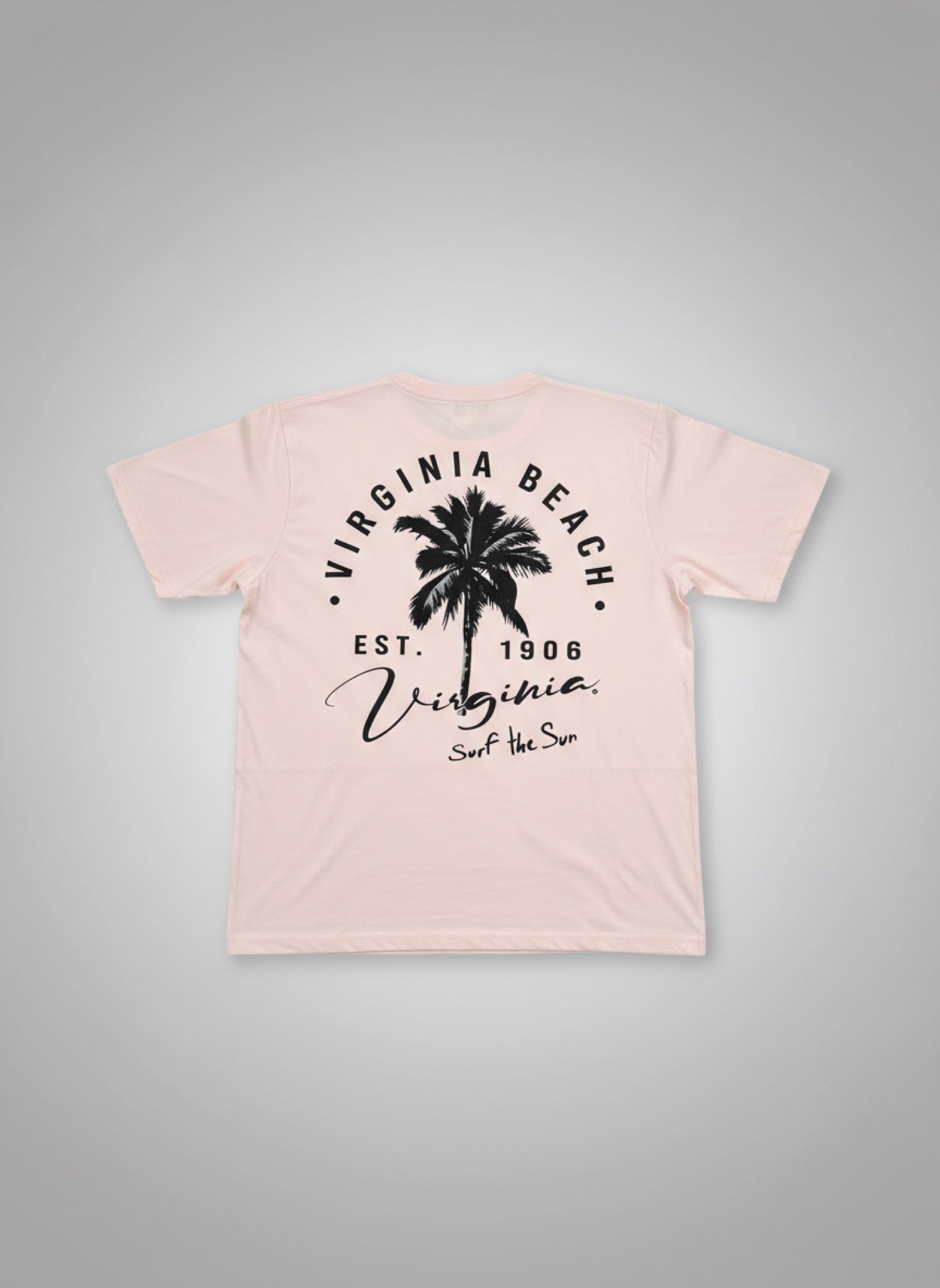 Pink t-shirt with black palm tree design and text on a gray background